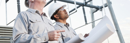 Engineers at industrial site looking up